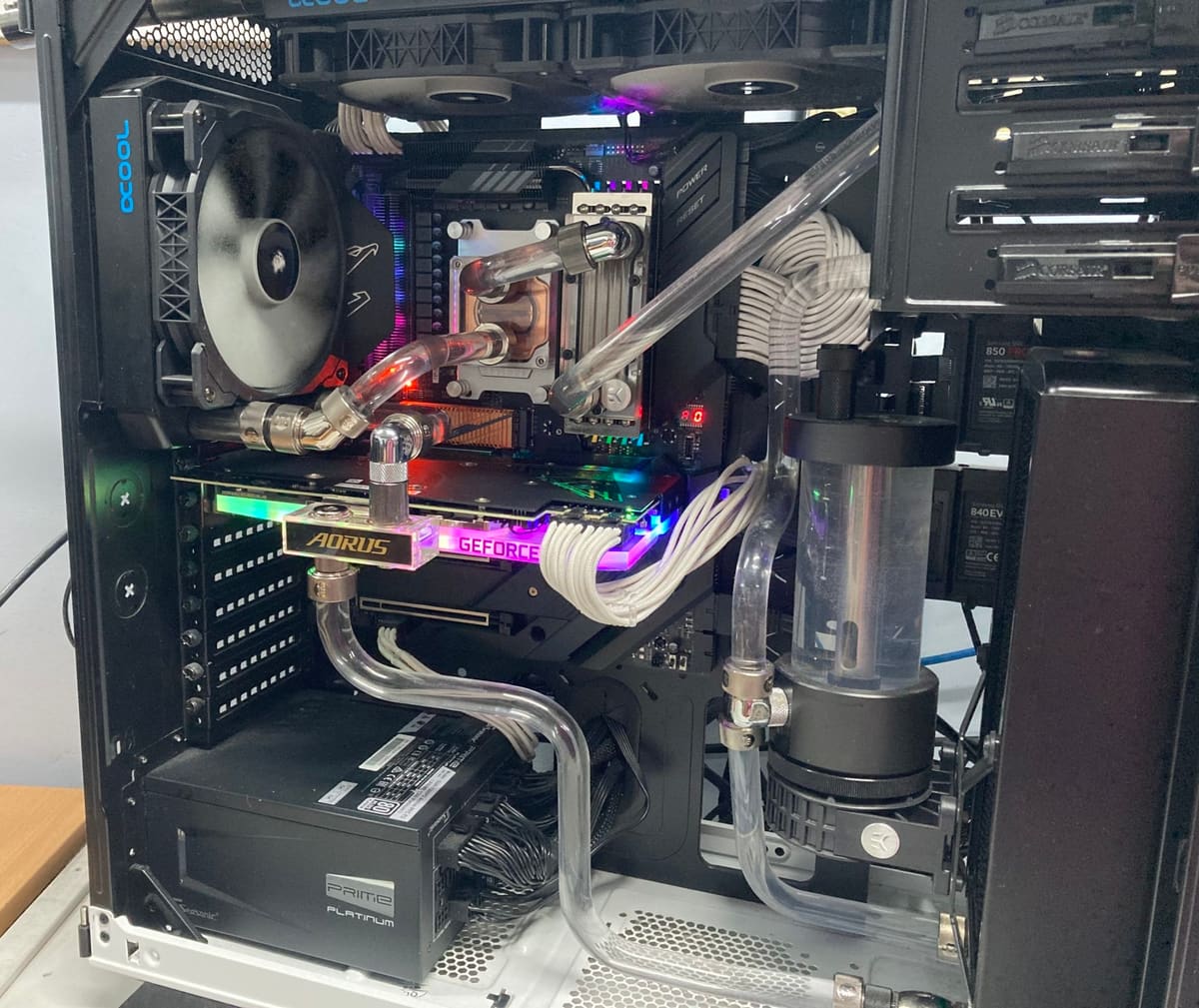 Custom hard-tube water-cooled gaming PC with RGB lighting, built at IC-Solutions
